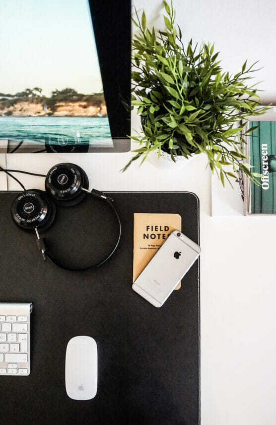 Field notes and head phones on desk